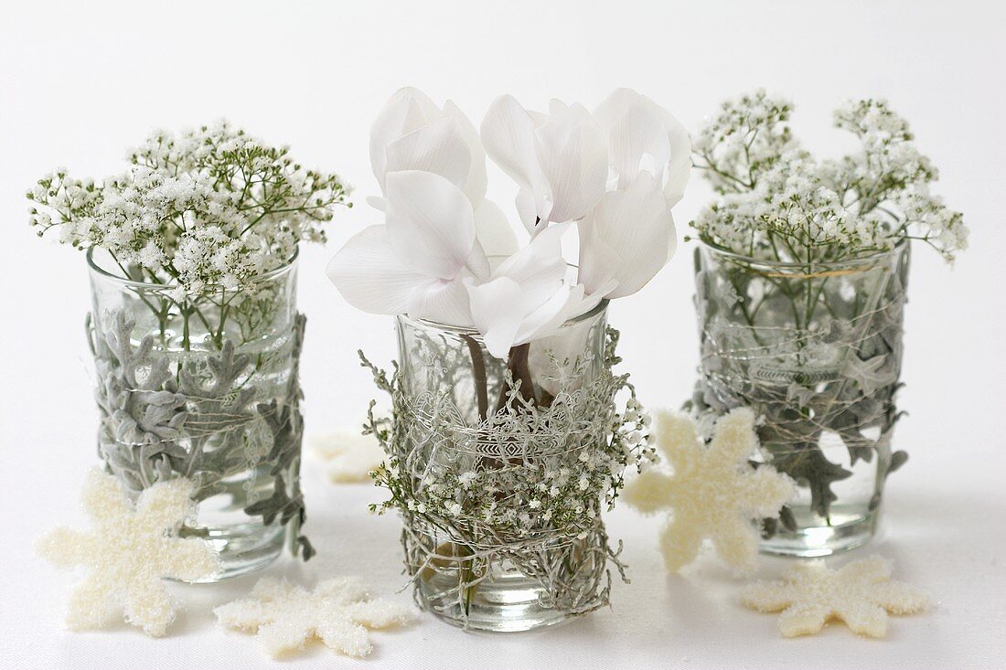 Gypsophila and cyclamen in decorated glass vases
