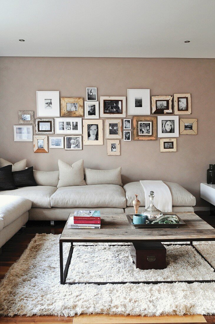 Living room with a corner sofa and photos on the wall