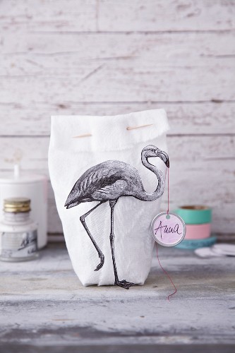 A fabric bag decorated with a flamingo print