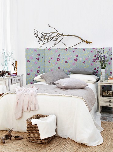 Fabric-covered bed headboard with folding sides in bedroom in natural style