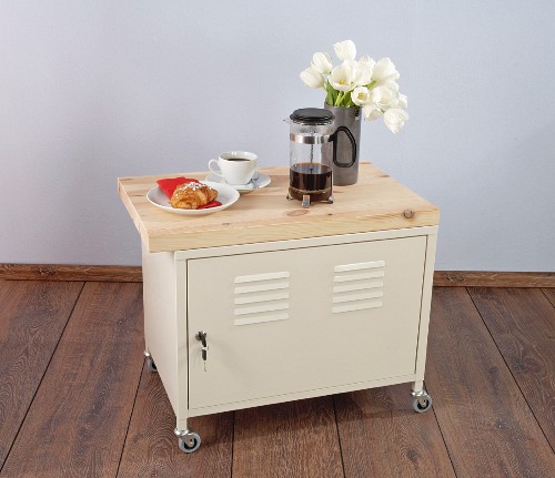 Breakfast and flowers on locker with castors and wooden top