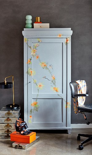 Grey cupboard painted with floral ornaments in study