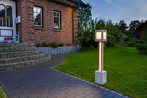 Hand-made garden lantern next to path in front garden