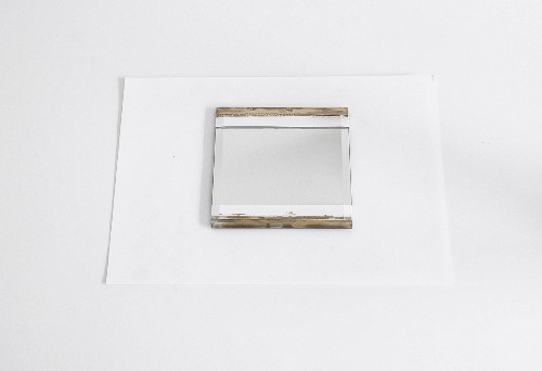 Mirror with areas masked with white masking tape and painted stripes