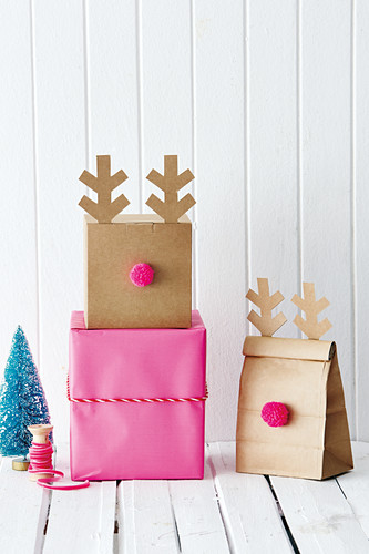 Gift boxes and bags decorated with pompoms and antlers