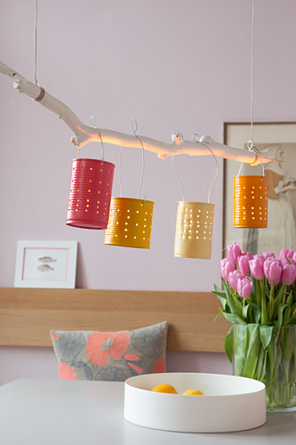 Handmade lamp made from branch and painted tin cans