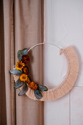 Macramé wreath in dusky pink with everlasting flowers and eucalyptus leaves