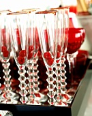 Tray of champagne flutes (with raspberries in) and glasses