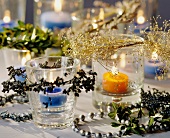 Tea lights with Christmassy branches as table decoration