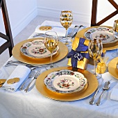 Christmas table laid in blue and gold