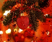 Strawberry-shaped tree ornament in red light