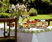 Table decorated with marguerites in garden