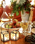 Two small hurricane lamps as autumnal table decoration