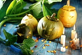 Halloween pumpkins on blue wooden table, candles nearby