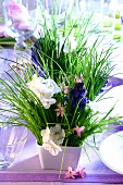 Table flower arrangements with chives, violets and hyacinths