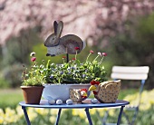 Flowerpots and Easter decoration on garden table