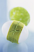 White egg with green ribbon