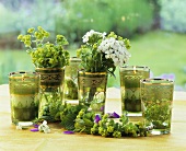 Tea glasses decorated with garden flowers and candles