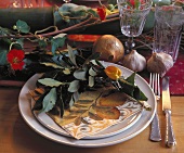 Place-setting decorated with bay leaves and physalis