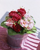Bouquet of double and single roses and strawberry flowers