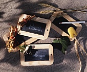 Slates in wooden frames as place cards
