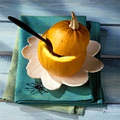 Hollowed-out pumpkin with spoon for Halloween pumpkin soup