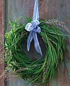 Wreath of prairie cordgrass, hanging on a wooden wall