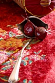 Two cooked beetroots in ladle on carpet