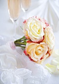 Bouquet of roses in front of champagne glasses