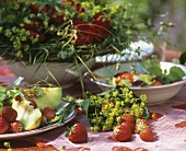 Summery table with strawberries, melon and lady's mantle