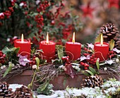 Wintry arrangement with candles in snow