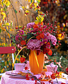 Autumn flower arrangement on table in open air