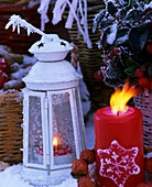 White lantern with candle in snow