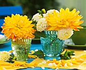 Yellow and white dahlias in glasses