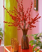 Red winterberries in vase