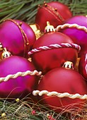 Christmas tree baubles decorated with festive cord