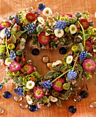 Heart-shaped wreath with daisies and grape hyacinths