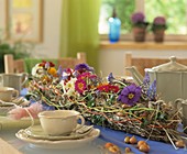 Table with flower garland, cups and teapot