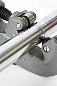 Cutting a chromium rail with a pipe cutter (close-up)