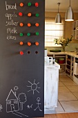 View into a kitchen with a blackboard sliding door