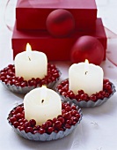 Candles and cranberries in tart tins
