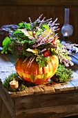 Autumnal flower arrangement in pumpkin vase
