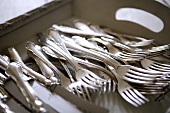 Silver cutlery on tray (close-up)