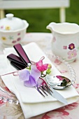 Place-setting with floral decoration on garden table