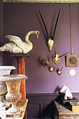 Hunting trophies, stone urn and horse's head ornament