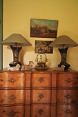 Two table lamps on a chest of drawers