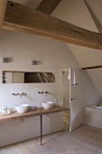 Attic bathroom with twin sinks on simple wooden washstand