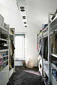 Sunny dressing room with ceiling lamp and white shelving units