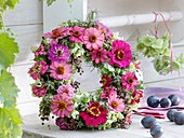 Wreath of late summer flowers in pink and green