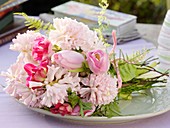 Bunch of spring flowers (tulips, hyacinths etc.) on plate
